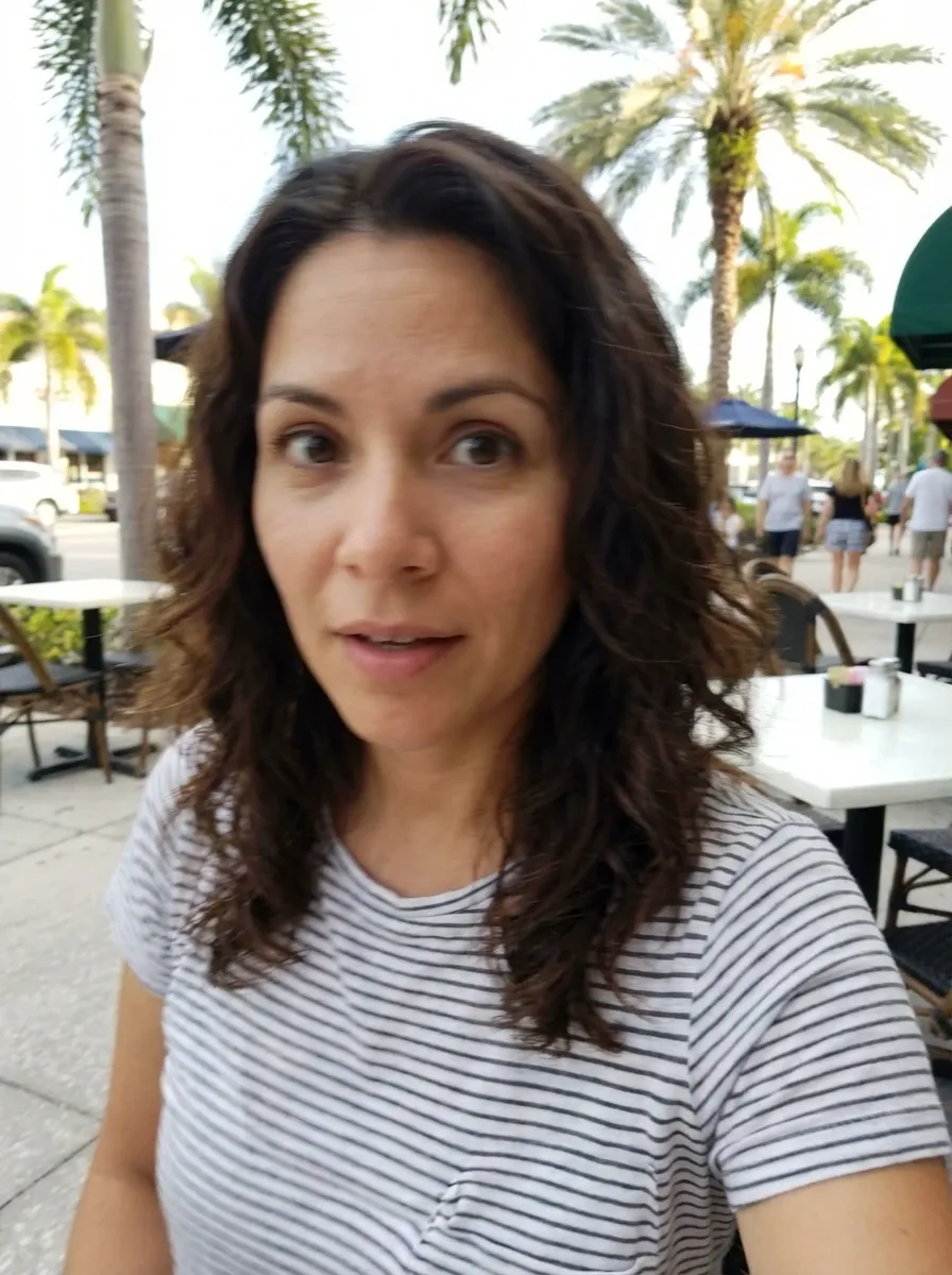 Original selfie input — woman in a striped T-shirt outdoors